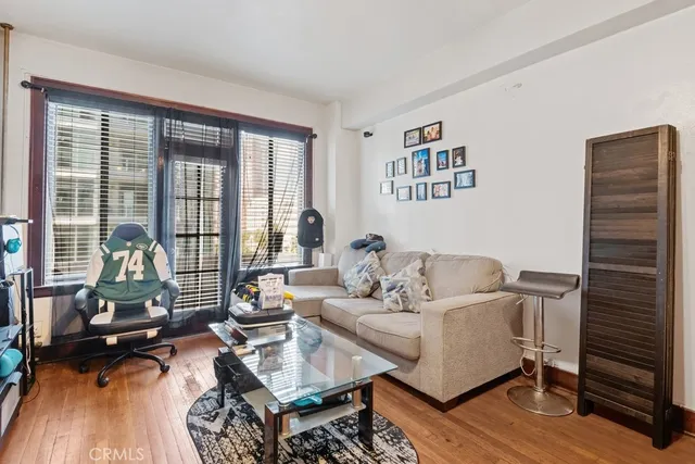 a living room with furniture and floor to ceiling window