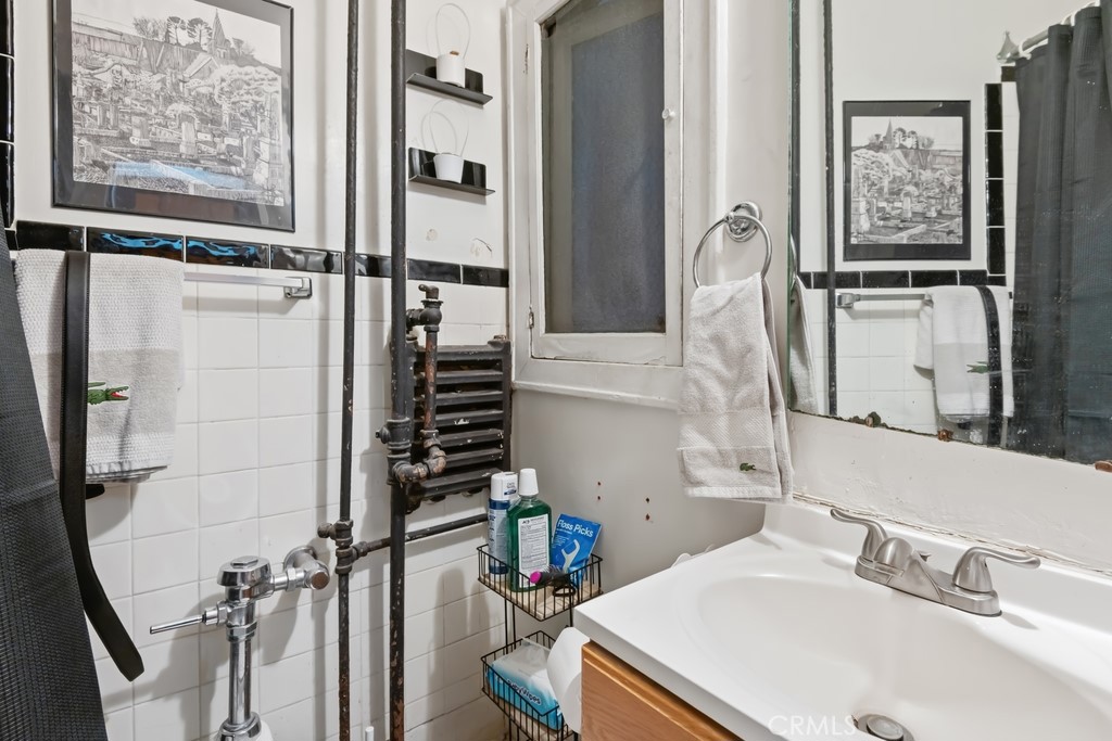360 West Ocean Boulevard, Unit 706 Long Beach, CA 90802 - Photo 8 of 22 a bathroom with a sink and a mirror