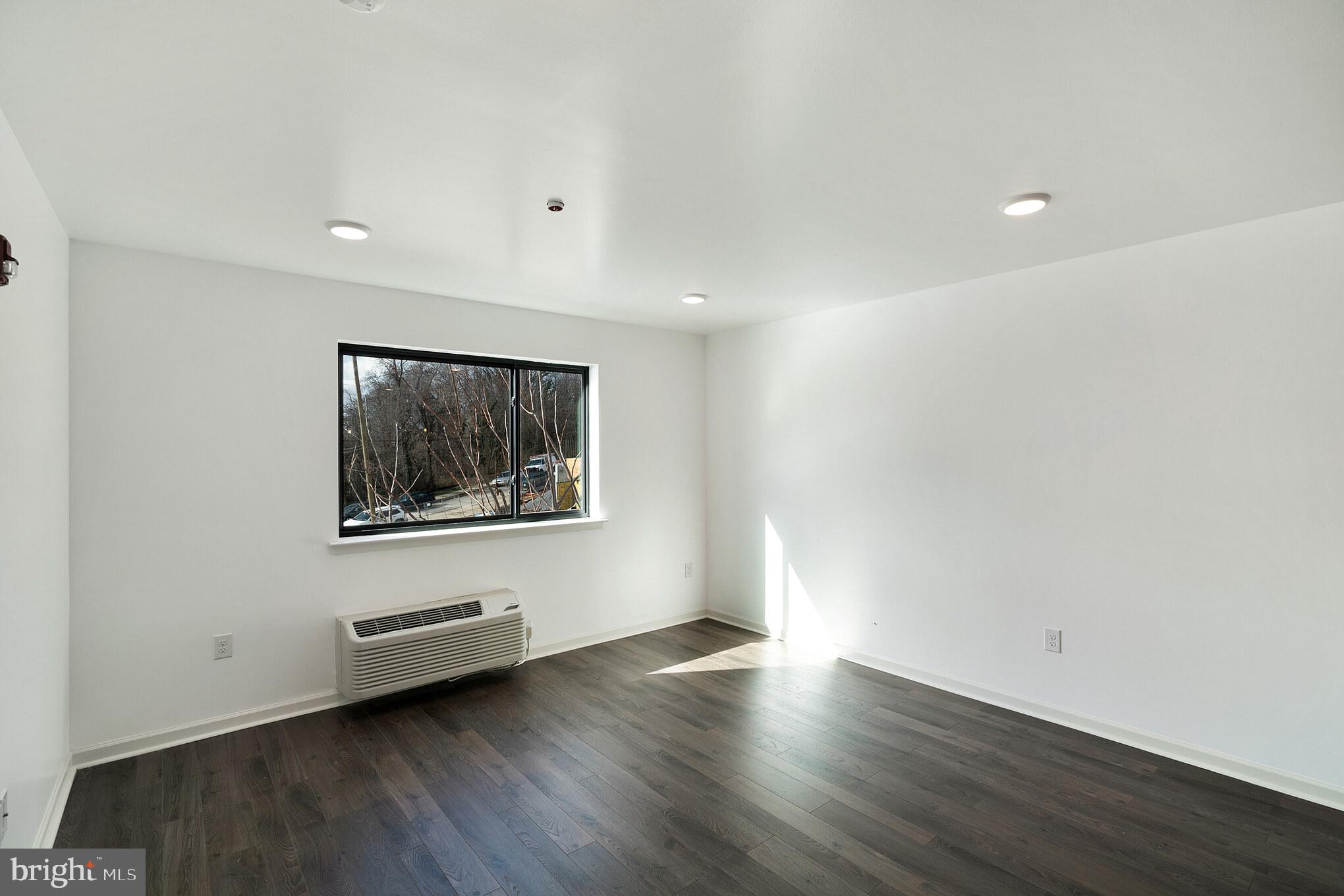 5420 Ridge Avenue, Unit 406 Philadelphia, PA 19128 - Photo 6 of 10 a view of a livingroom with wooden floor and window