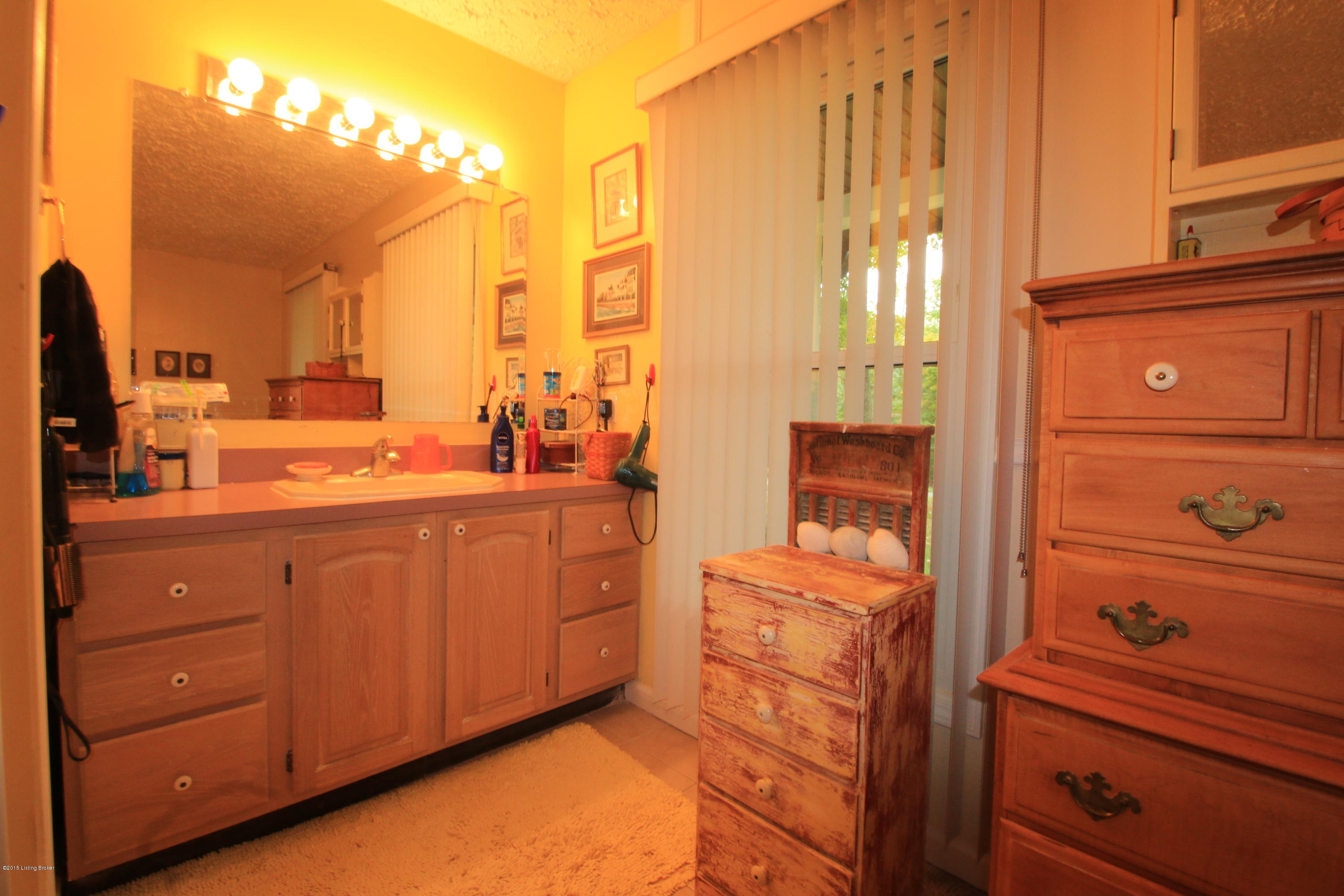 106 Callis Grove Pendleton, KY 40055 - Photo 25 of 36 The master bathroom is finished with tile flooring, a cherry color palette, large vanity with plentiful storage, and bright lighting.
