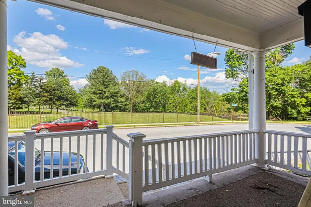 a view of a house with a small yard and wooden fence