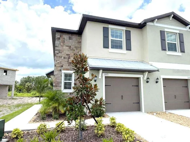 a front view of a house with a yard and garage