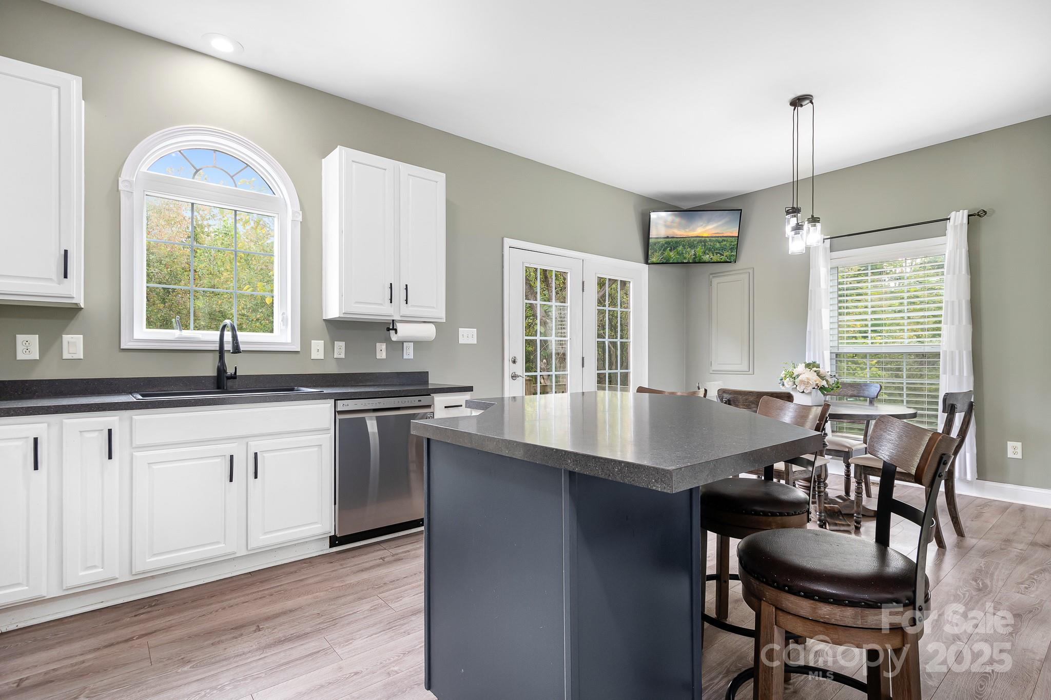 4654 Rocky Hollow Road Davidson, NC 28036 - Photo 11 of 48 a kitchen with granite countertop lots of counter top space and dining table