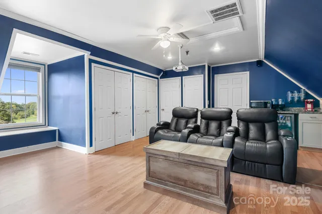 a view of a house with a yard and potted plants