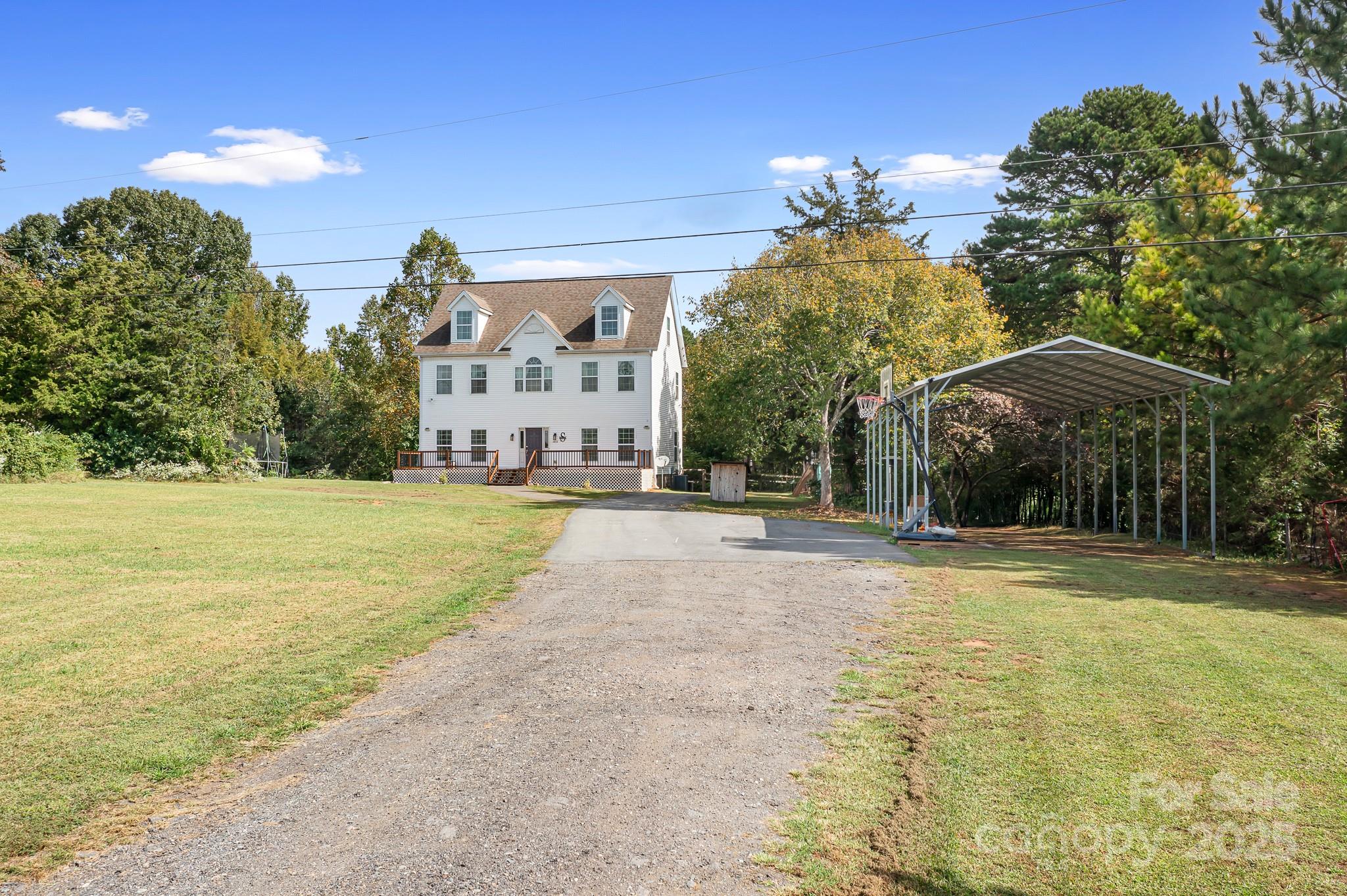4654 Rocky Hollow Road Davidson, NC 28036 - Photo 30 of 48 a view of a house with a yard and potted plants