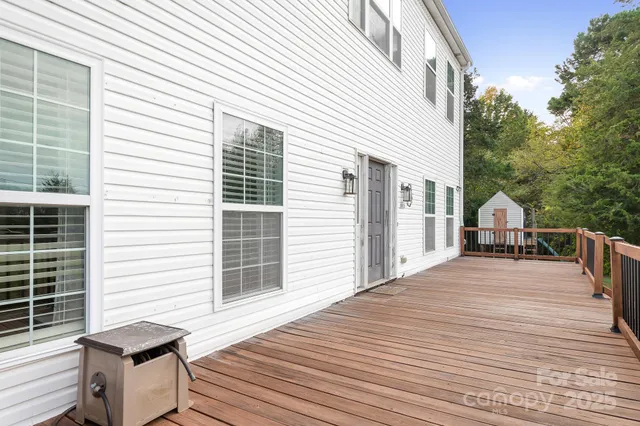 a view of a roof deck with wooden floor and fence