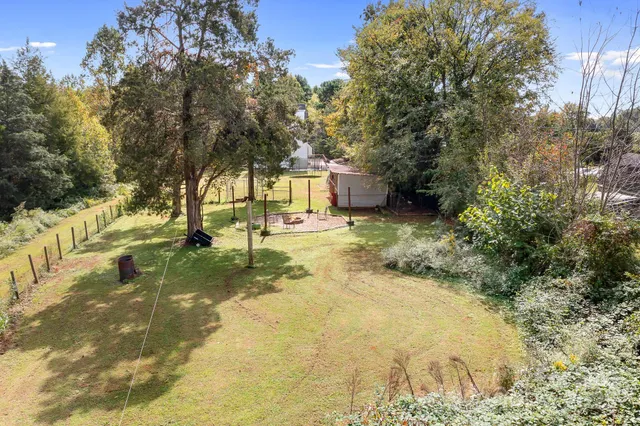 a view of a house with a yard and garage