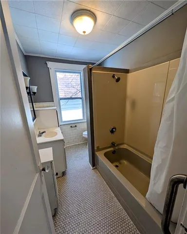a bathroom with a tub and a shower