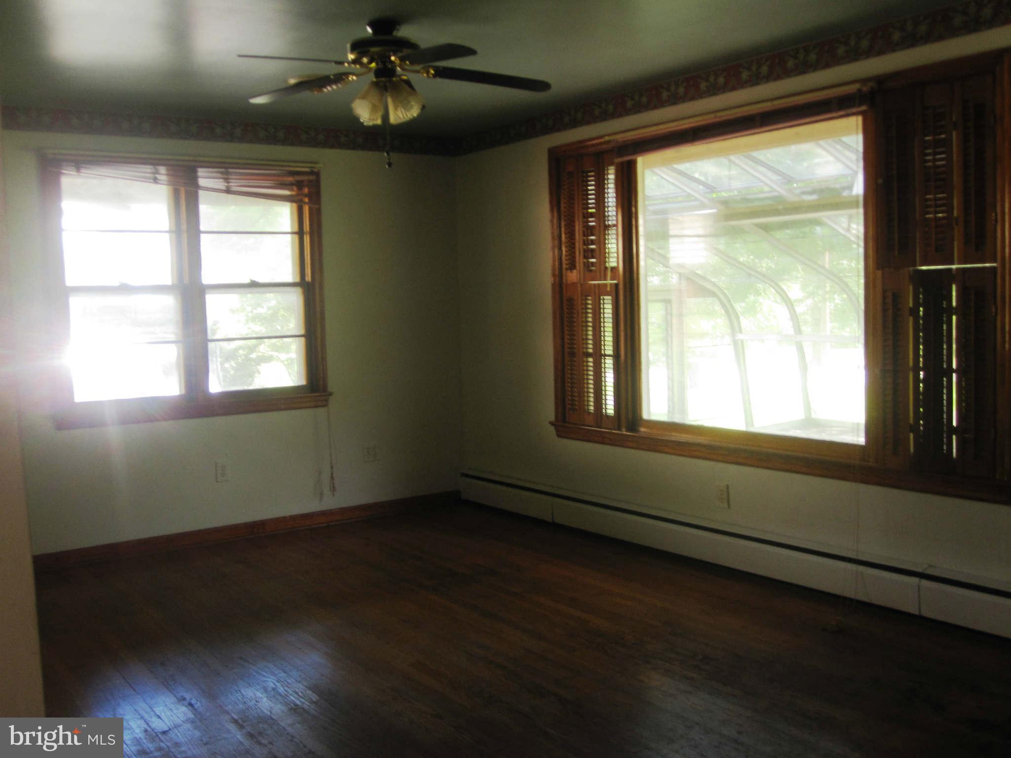 7204 Bowers Road Frederick, MD 21702 - Photo 12 of 26 a view of an empty room with wooden floor and a window