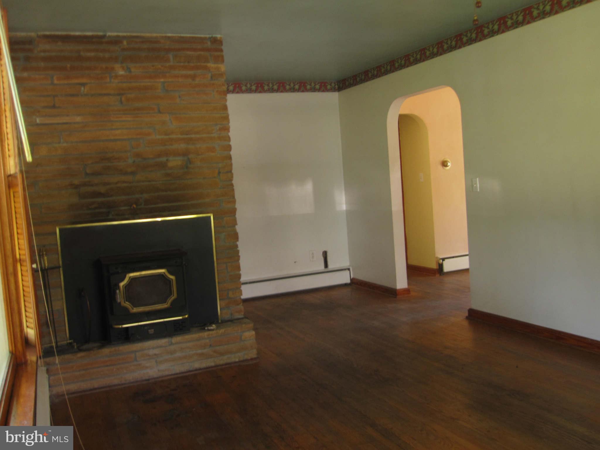 7204 Bowers Road Frederick, MD 21702 - Photo 13 of 26 a view of an empty room with wooden floor and a fireplace