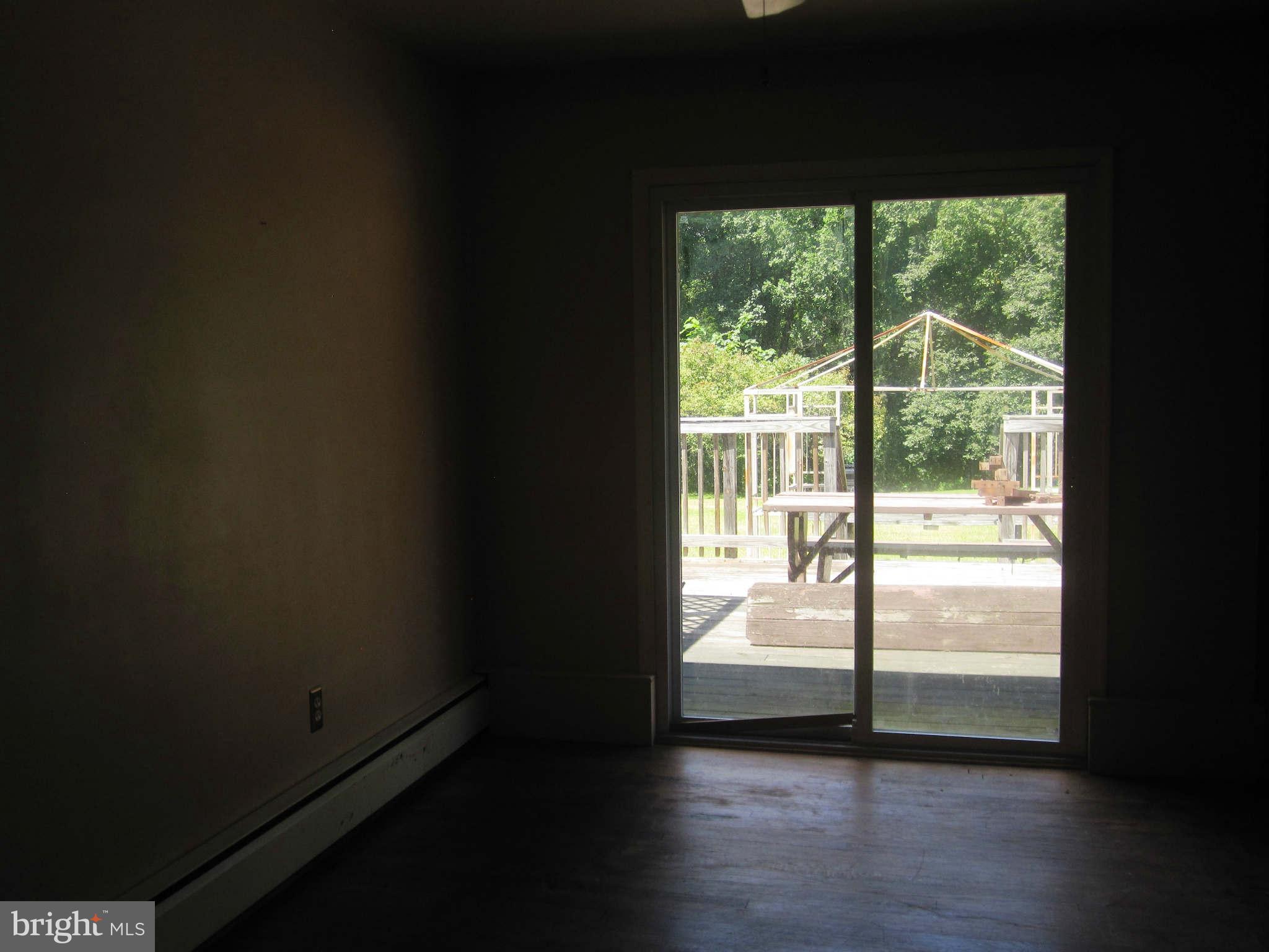 7204 Bowers Road Frederick, MD 21702 - Photo 8 of 26 a view of a big room with wooden floor and a window