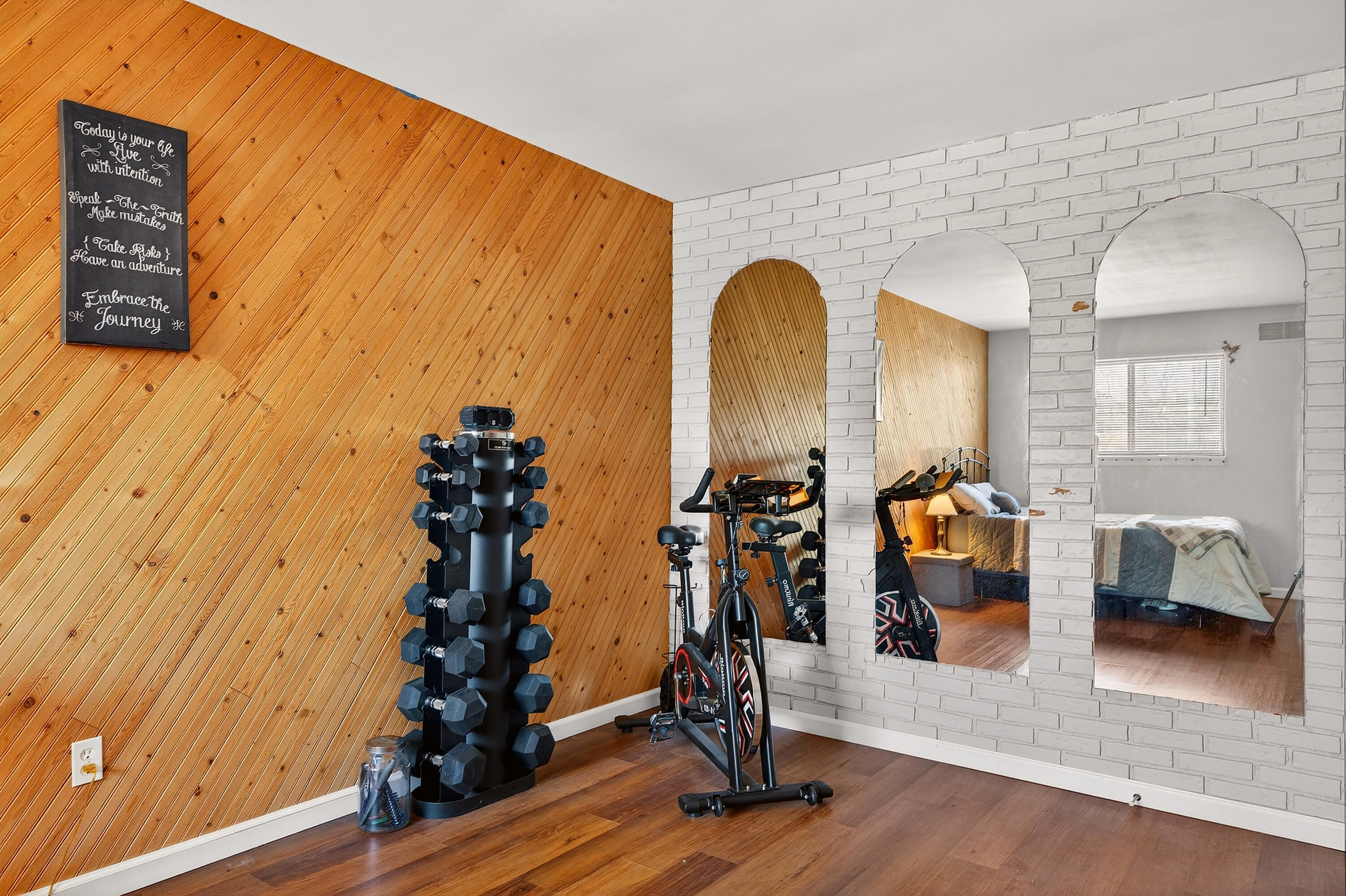 8305 North 107th Street, Unit F Milwaukee, WI 53224 - Photo 14 of 22 Accent wall and architectural mirrors add character.