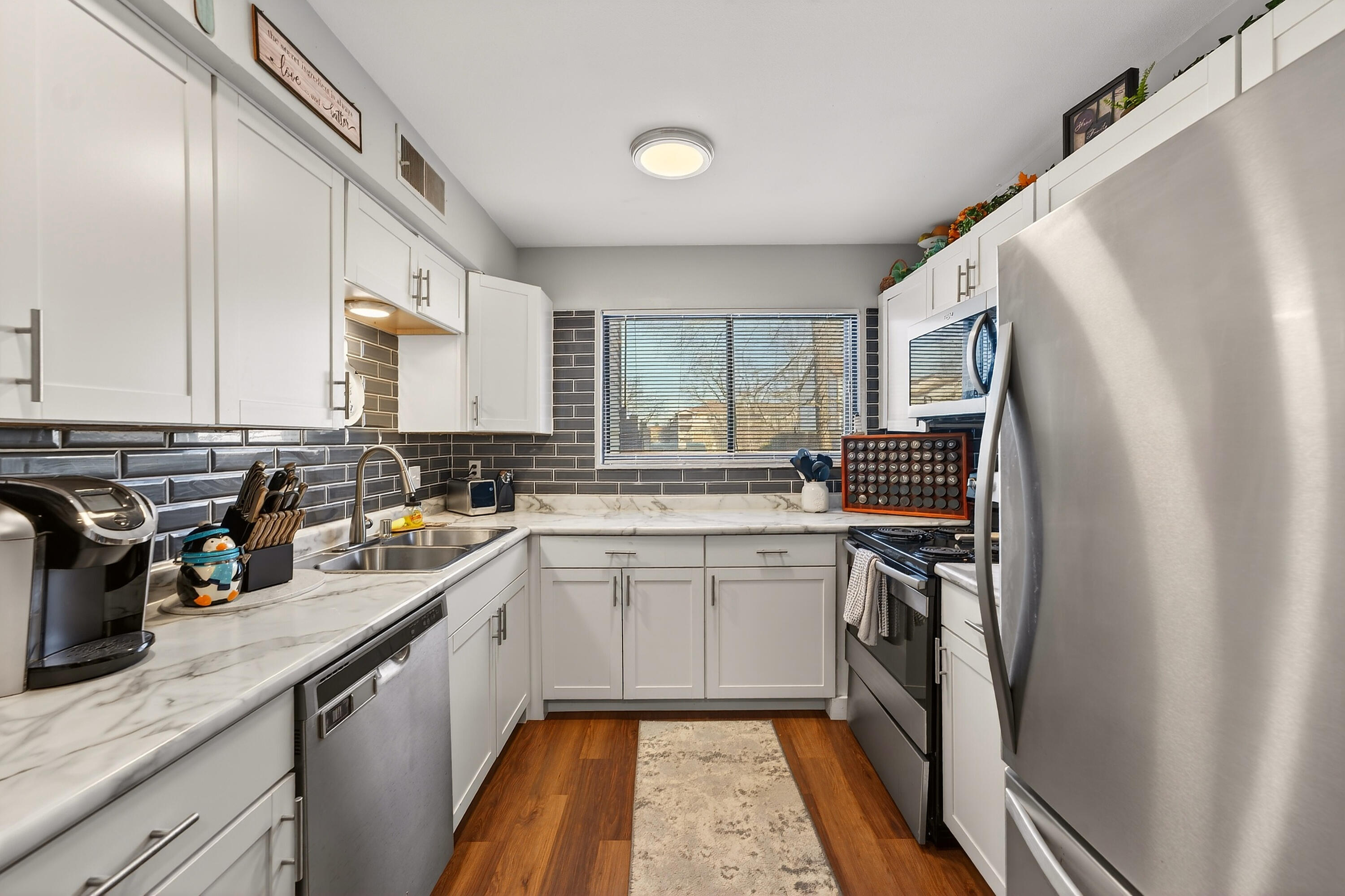 8305 North 107th Street, Unit F Milwaukee, WI 53224 - Photo 3 of 22 Updated kitchen with natural light and stainless appliances.