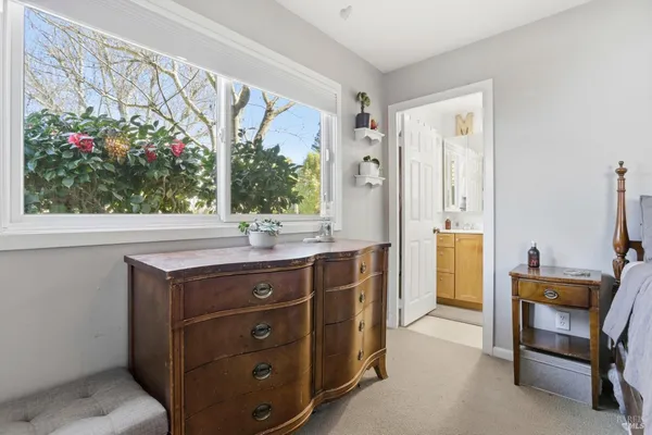 a bed sitting in a bedroom next to a window