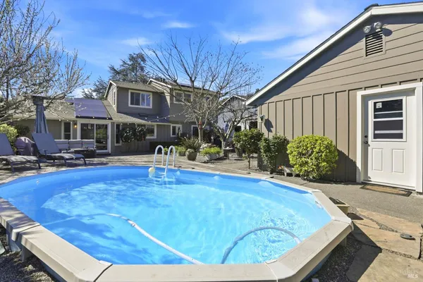 a view of a patio with couches and a fire pit
