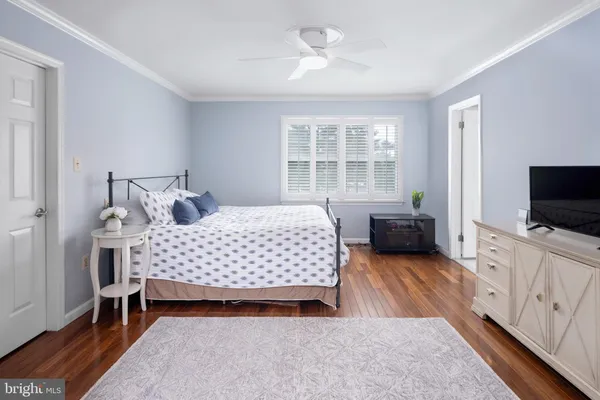 a bedroom with a bed and a flat screen television