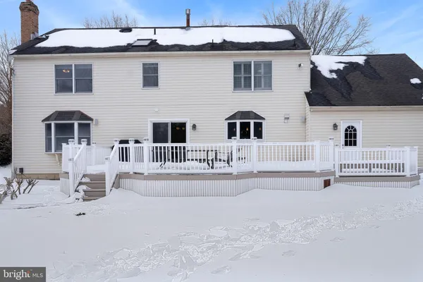 a view of a house with a white fence