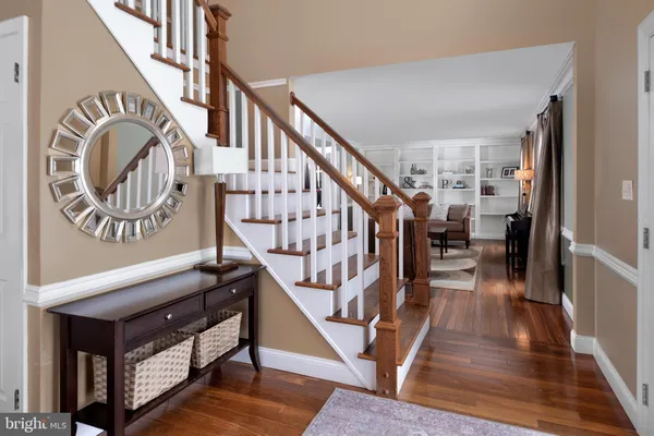a view of entryway and hall with wooden floor