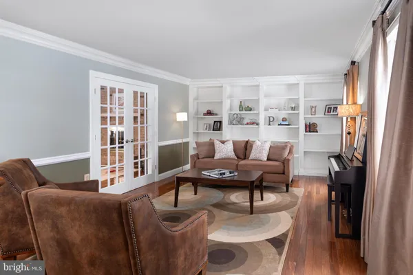 a living room with furniture a rug and a window