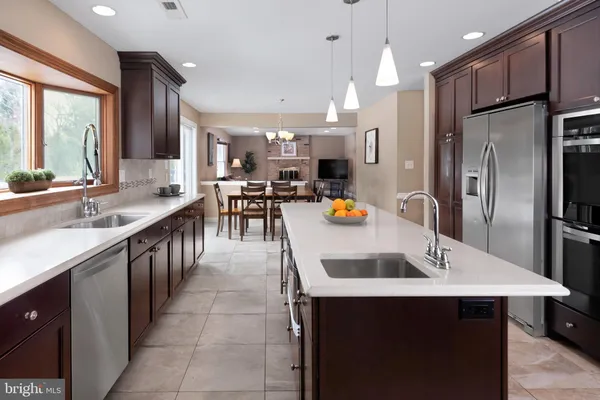 a kitchen with stainless steel appliances a sink stove and refrigerator