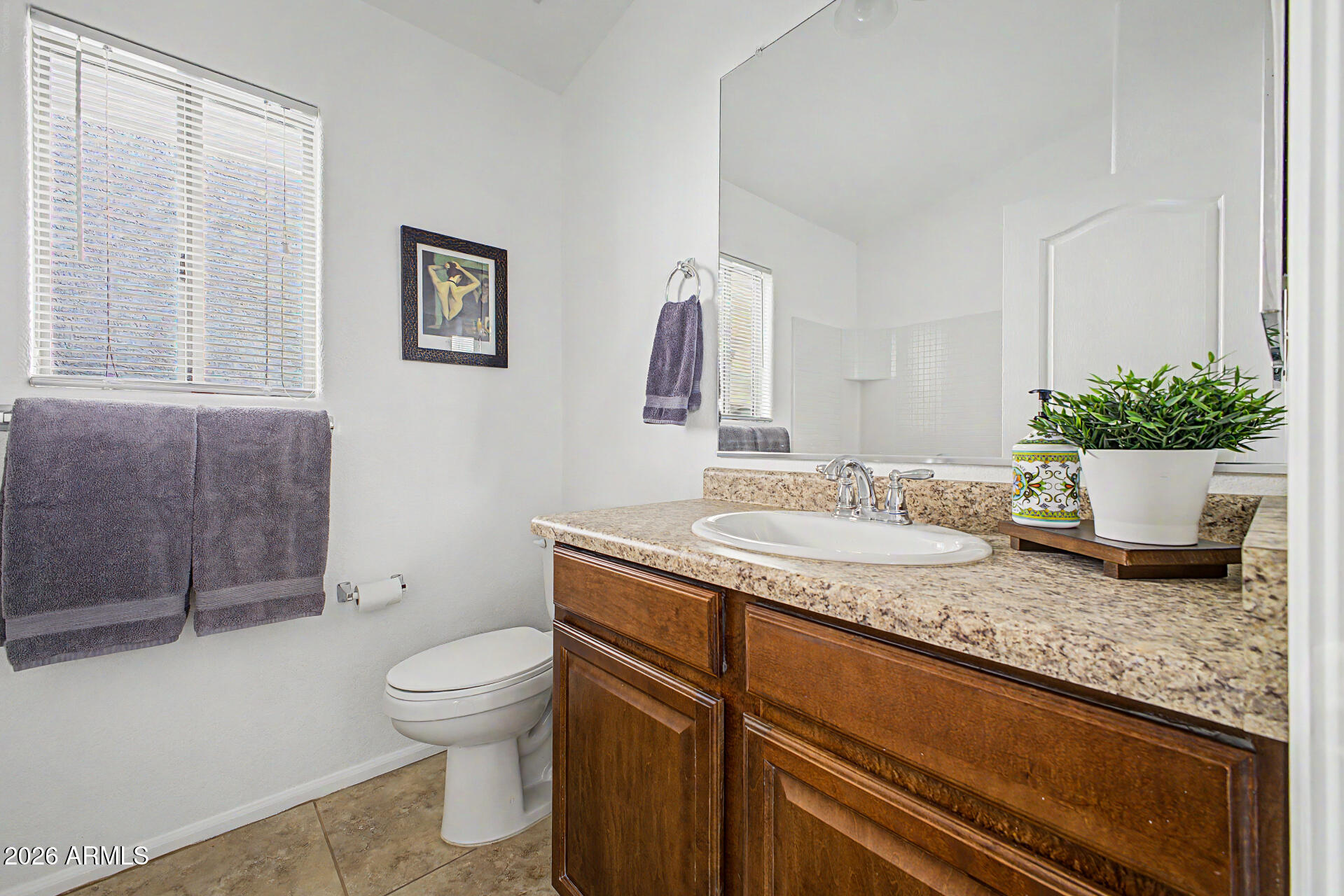 4168 East Sandy Way Gilbert, AZ 85297 - Photo 22 of 47 a bathroom with a granite countertop sink a toilet and mirror