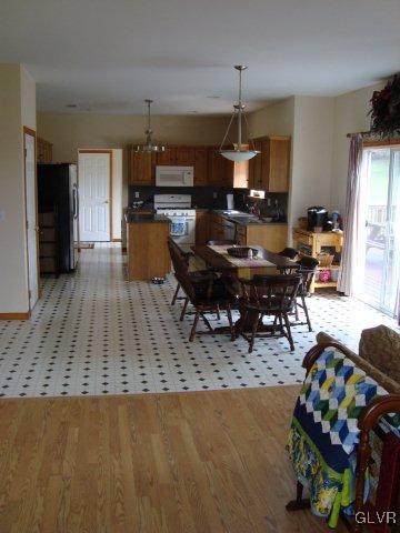 774 Bushkill Center Road Nazareth, PA 18064 - Photo 20 of 36 a living room with furniture and a dining table with kitchen appliances