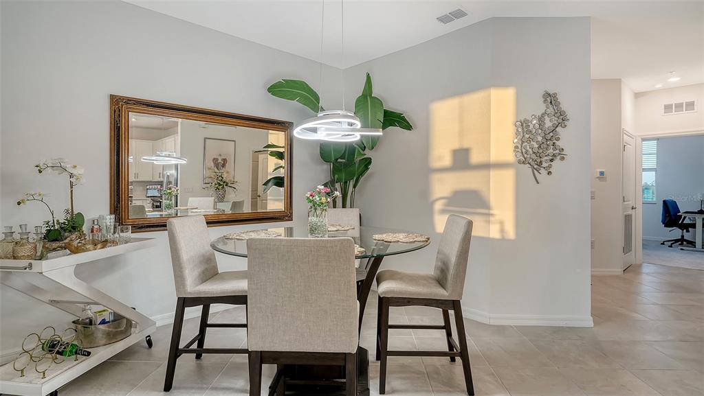 12140 Wellen Golf Street, Unit 301 Venice, FL 34293 - Photo 16 of 85 a view of a dining room with furniture window and wooden floor