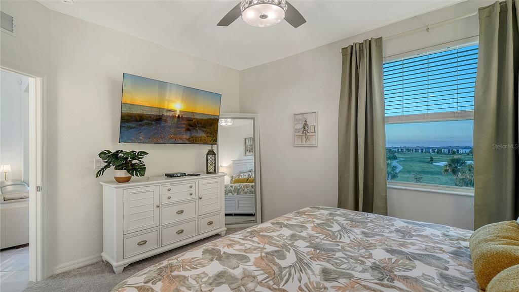 12140 Wellen Golf Street, Unit 301 Venice, FL 34293 - Photo 19 of 85 a bedroom with a bed and a chandelier