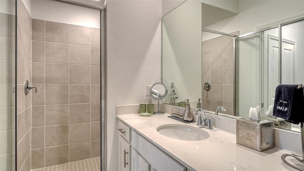 12140 Wellen Golf Street, Unit 301 Venice, FL 34293 - Photo 24 of 85 a bathroom with a granite countertop sink a toilet and shower