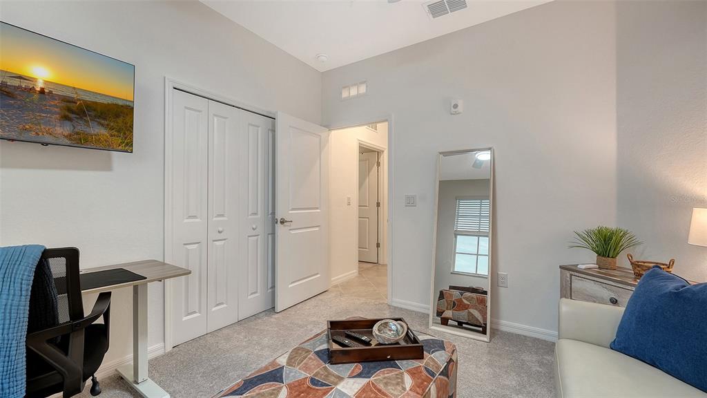 12140 Wellen Golf Street, Unit 301 Venice, FL 34293 - Photo 30 of 85 a living room with furniture and a flat screen tv