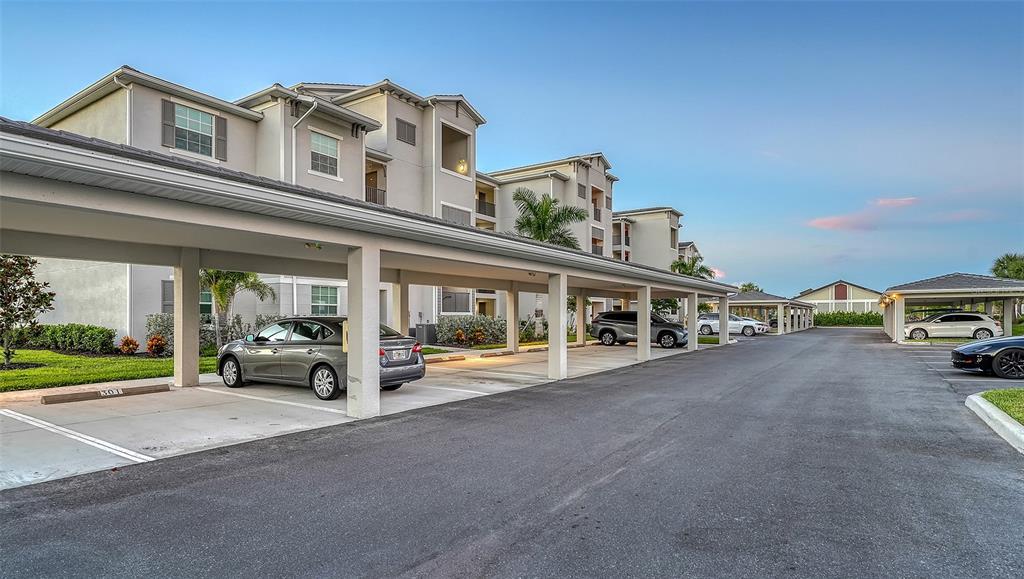 12140 Wellen Golf Street, Unit 301 Venice, FL 34293 - Photo 4 of 85 a view of a car park in front of a building