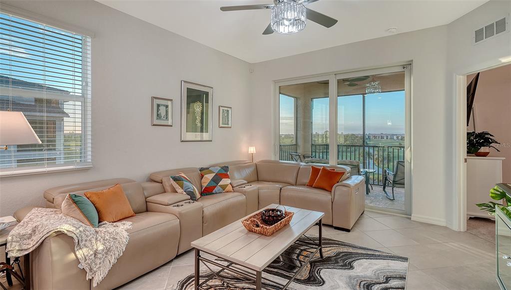 12140 Wellen Golf Street, Unit 301 Venice, FL 34293 - Photo 6 of 85 a living room with furniture and a large window