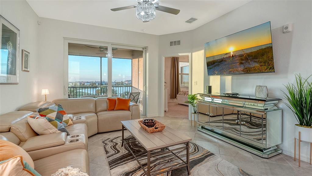 12140 Wellen Golf Street, Unit 301 Venice, FL 34293 - Photo 7 of 85 a living room with furniture and a flat screen tv