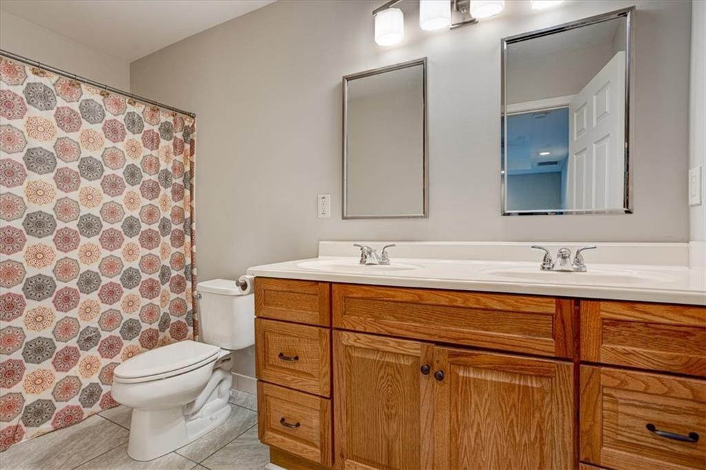 174 Rivertown Road Fairburn, GA 30213 - Photo 17 of 33 a bathroom with a toilet a sink and mirror