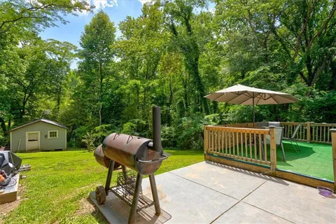 a view of a deck with furniture and a yard
