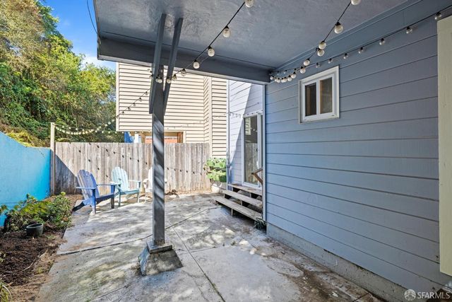 a view of a patio with table and chairs a barbeque with wooden fence