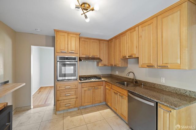 a kitchen with a sink cabinets and window
