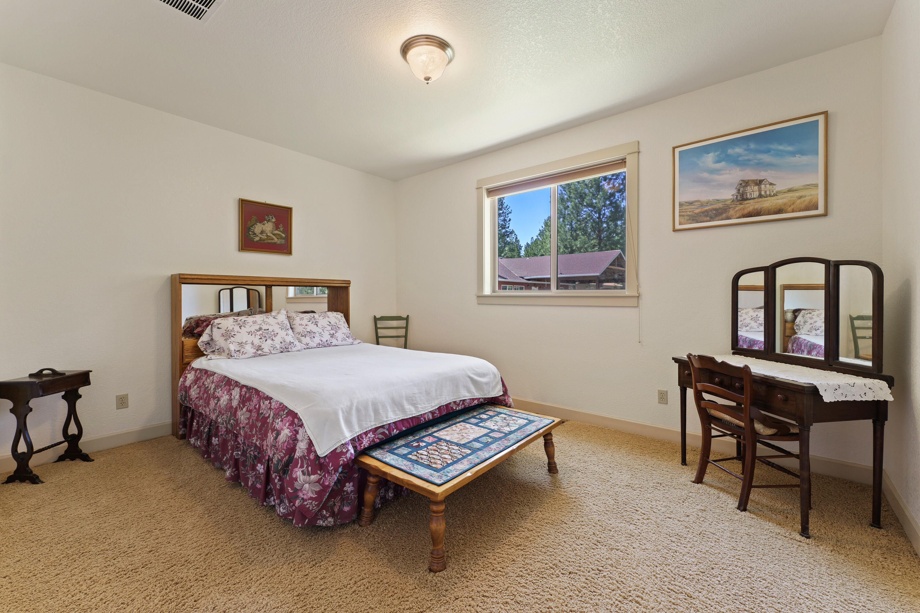 19236 Kiowa Road Bend, OR 97702 - Photo 27 of 52 a bedroom with a bed table chair and a window