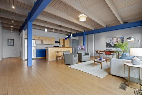 a living room with furniture and kitchen view