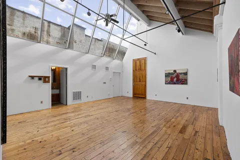 a view of hallway with wooden floor