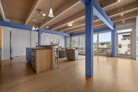 a view of a room with gym equipment and a large window