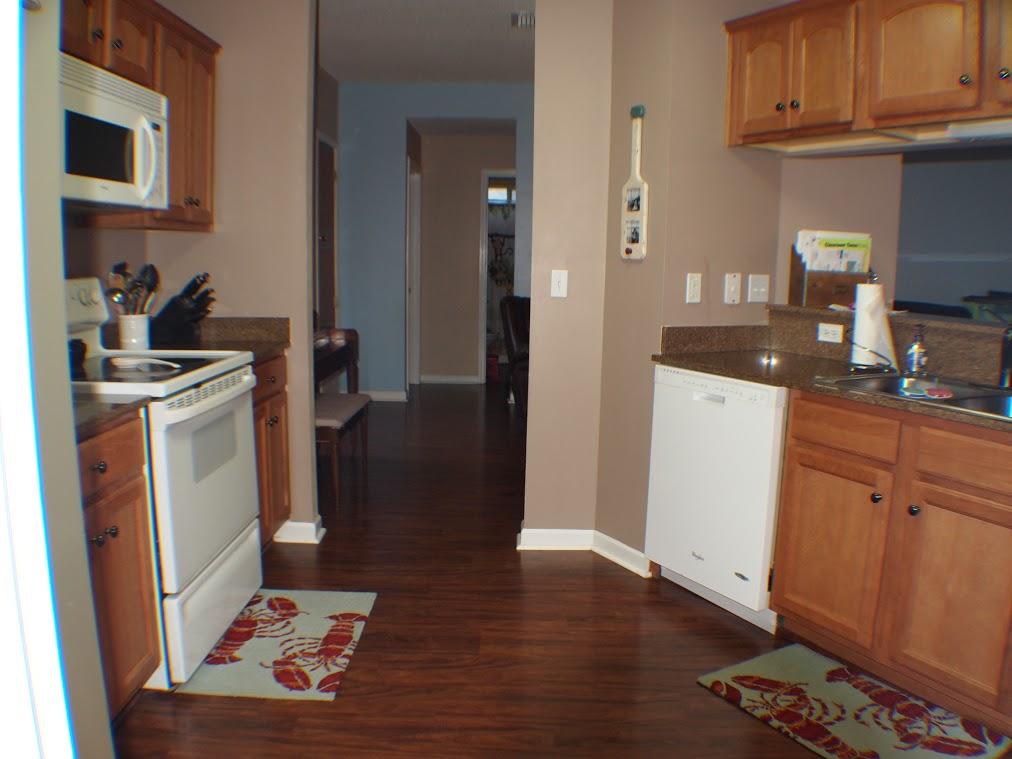 5220 Moore Loop Crestview, FL 32536 - Photo 12 of 24 a kitchen with a sink a refrigerator and cabinets
