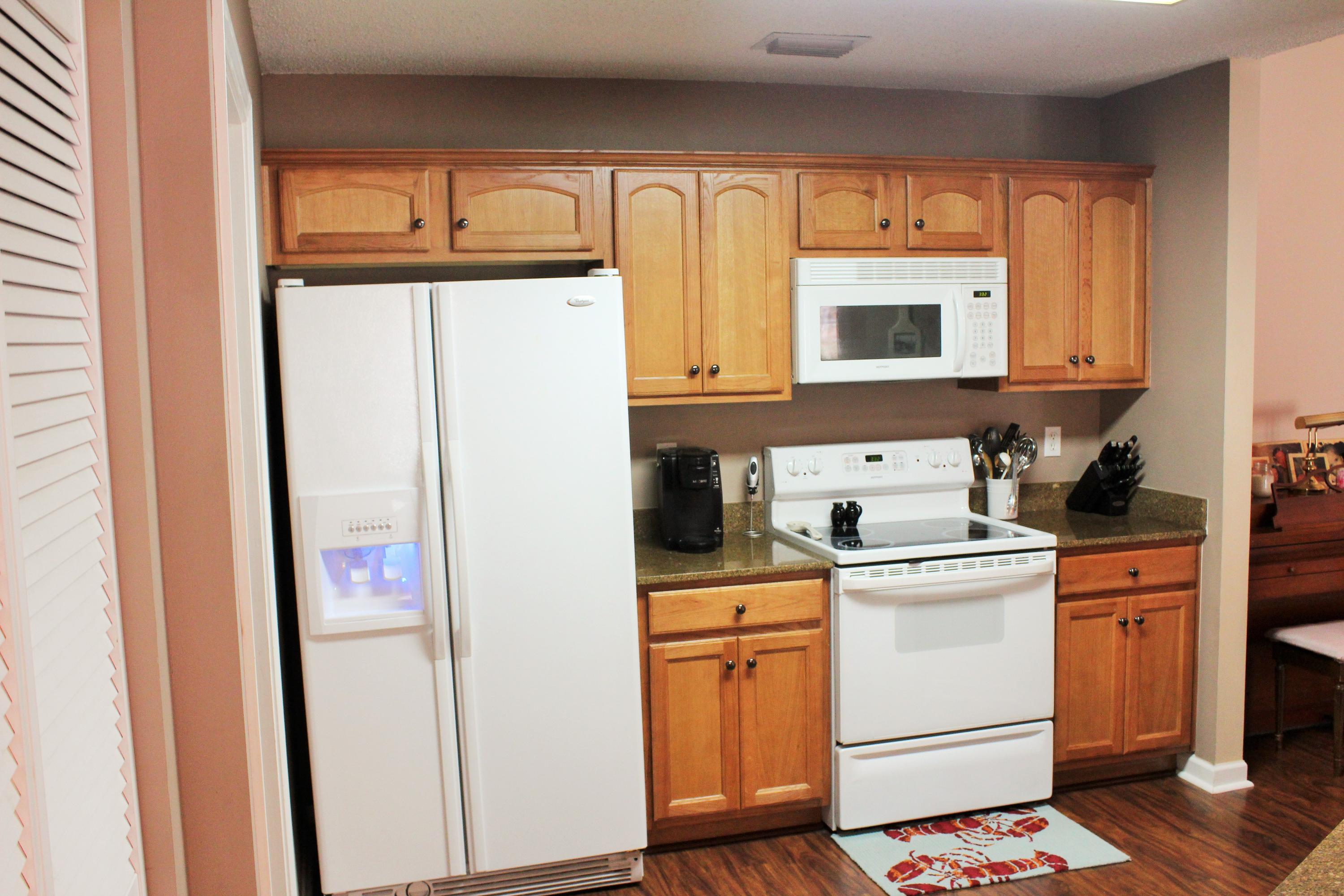 5220 Moore Loop Crestview, FL 32536 - Photo 4 of 24 a kitchen with a refrigerator sink and cabinets
