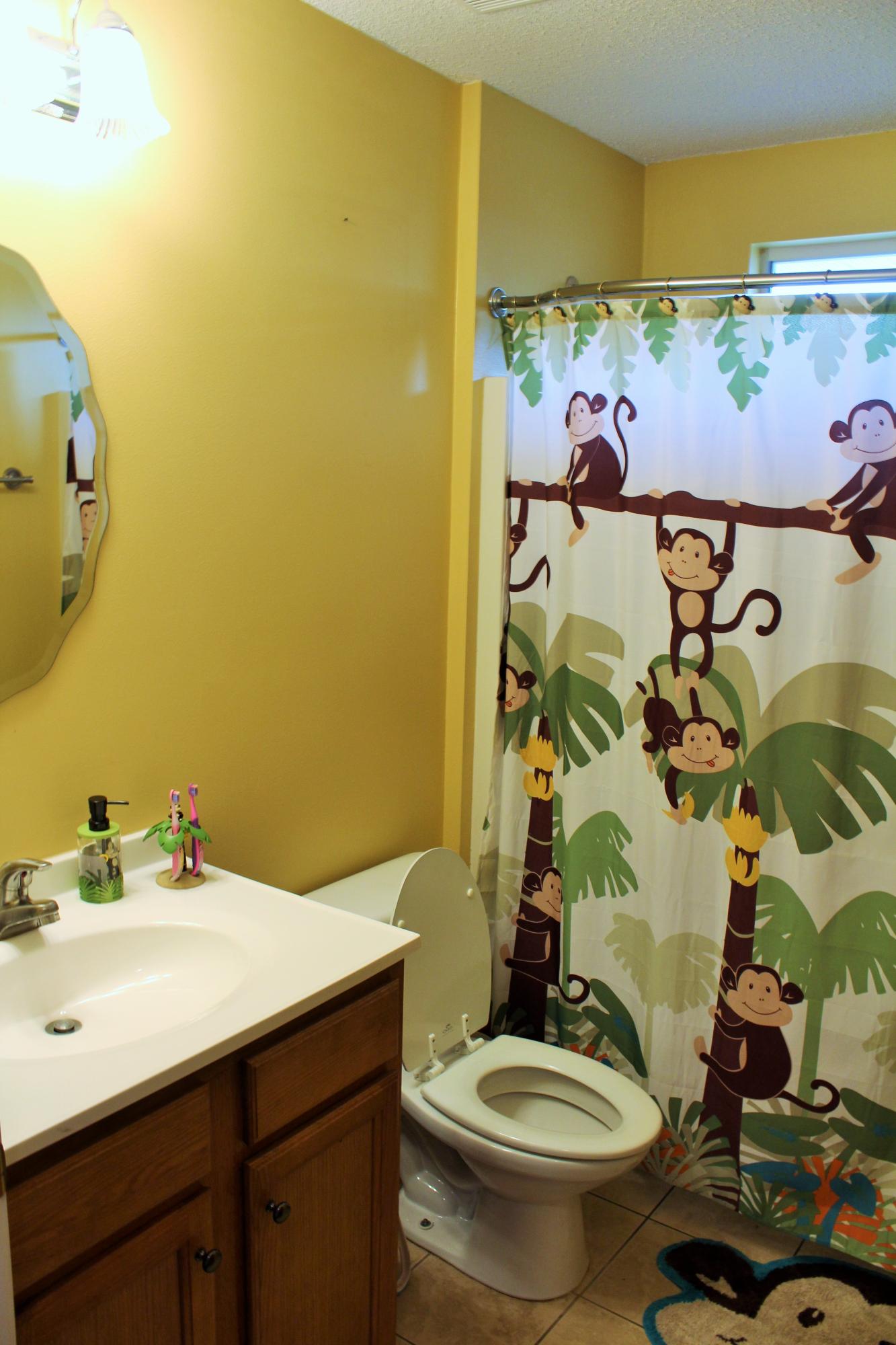 5220 Moore Loop Crestview, FL 32536 - Photo 9 of 24 a bathroom with a sink and mirror with toilet
