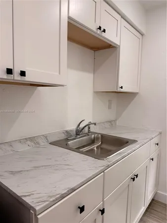 a kitchen with a sink and cabinets