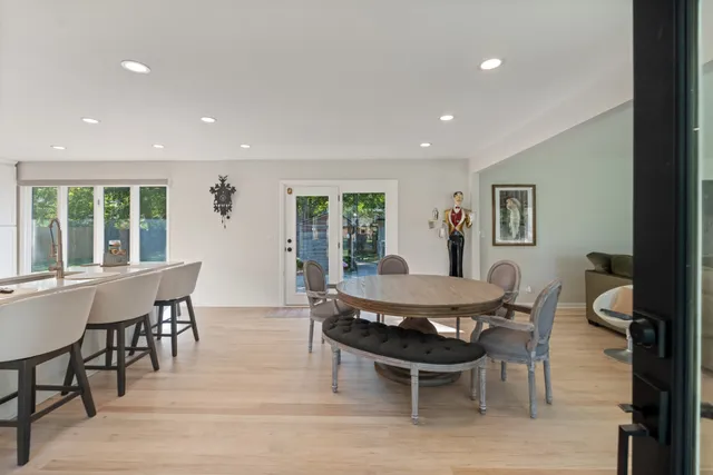 a living room with furniture a flat screen tv and a large window