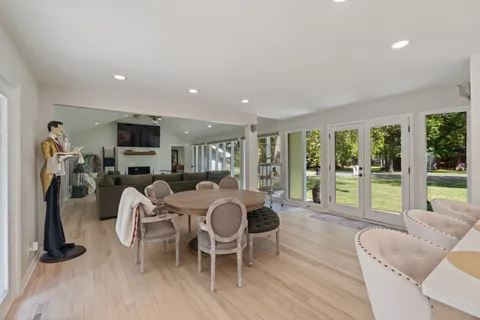 a walk in closet with wooden floor