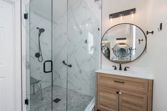 a bathroom with a shower and mirror