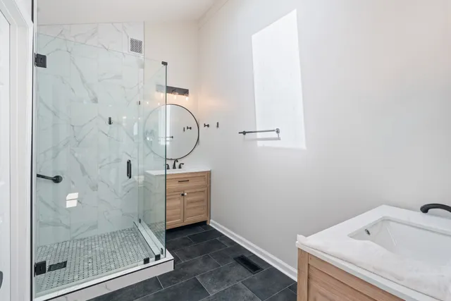a bathroom with a sink mirror and vanity