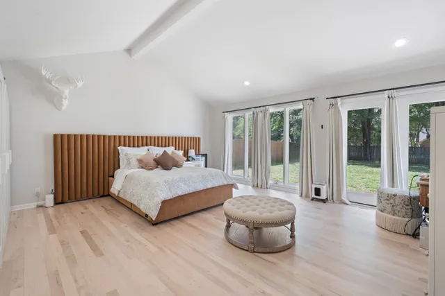 a living room with furniture a wooden floor and a sink